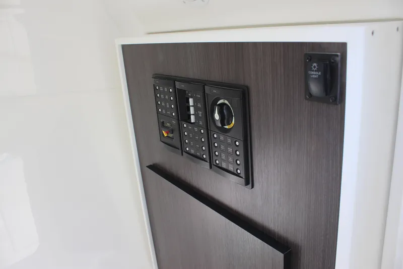 Slide: The Image of Control panel on 2022 Albemarle 27 DC boat, featuring modern switches and dials. - 29