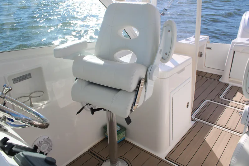 Slide: The Image of Luxury helm seat on 2022 Albemarle 27 DC boat with teak flooring. - 38