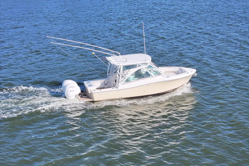 Slide: The Image of 2022 Albemarle 27 DC boat on water with dual engines, clear sky background. - 4