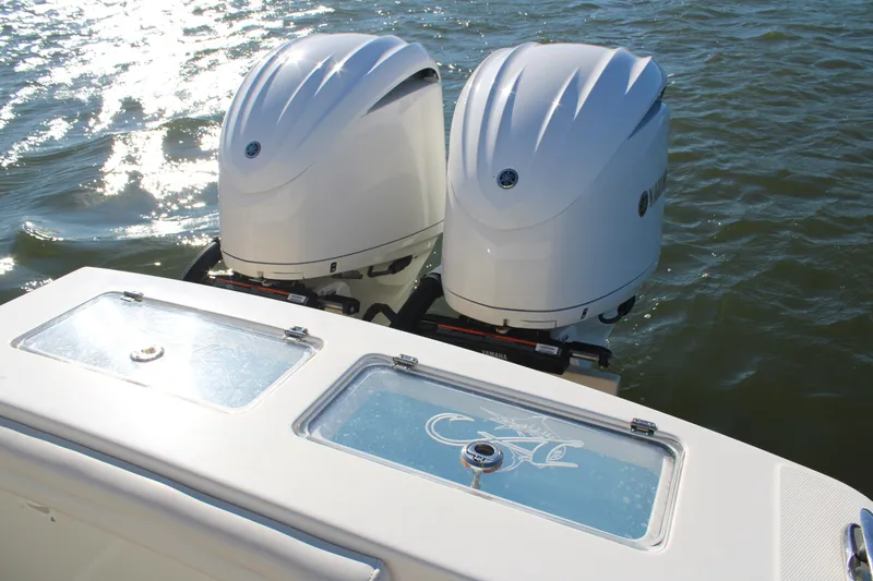 Slide: The Image of 2022 Albemarle 27 DC boat with dual outboard engines on water. - 41