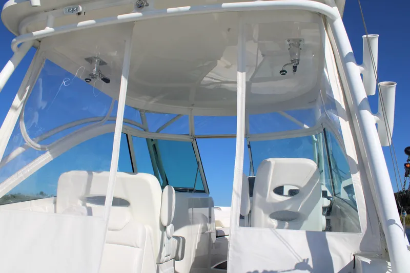 Slide: The Image of 2022 Albemarle 27 DC boat interior with white seating and clear windows against blue sky. - 44