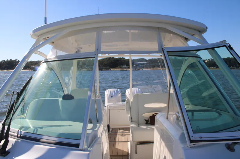 Slide: The Image of 2022 Albemarle 27 DC boat on water, featuring spacious cockpit and clear windshield. - 47