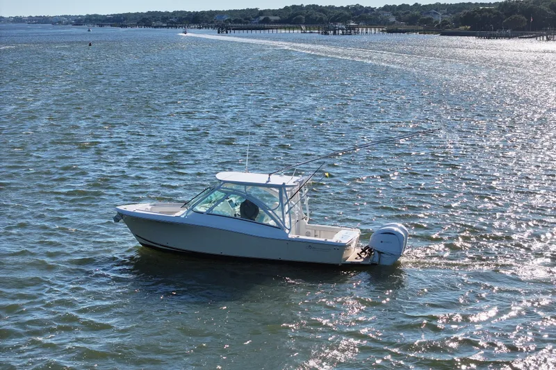 Slide: The Image of 2022 Albemarle 27 DC boat cruising on open water. - 5