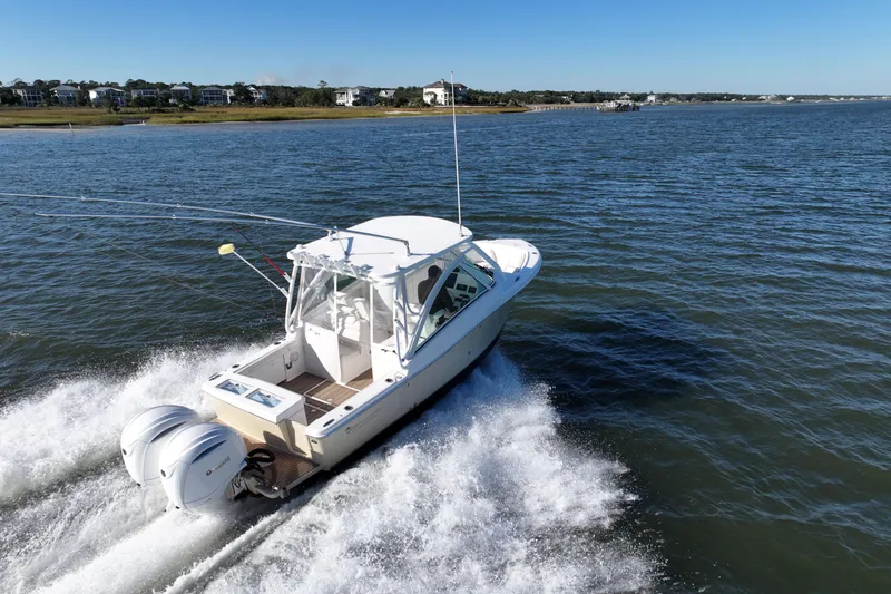 Slide: The Image of 2022 Albemarle 27 DC boat on water, aerial view, white exterior, dual engines. - 7