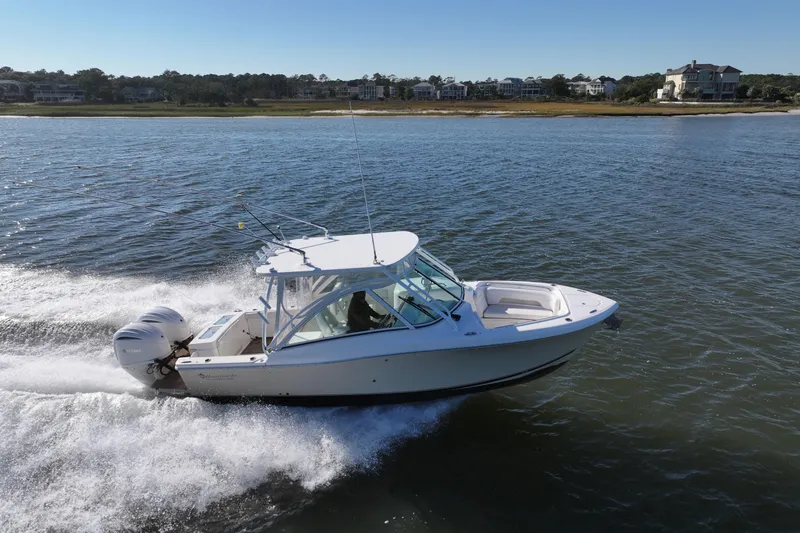 Slide: The Image of 2022 Albemarle 27 DC boat cruising on open water, showcasing twin engines. - 8