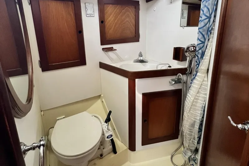 Slide: The Image of 1987 Bristol 41.1 Aft Cockpit bathroom with wooden cabinets and compact fixtures. - 12