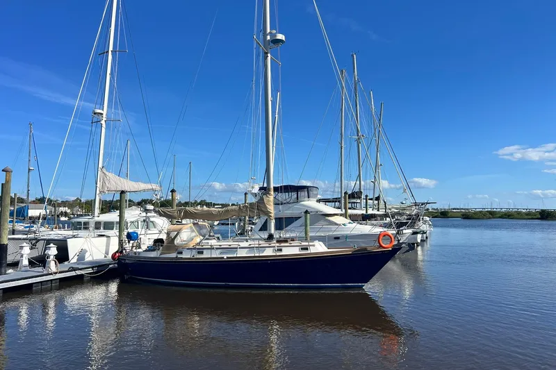 Slide: The Image of 1987 Bristol 41.1 Aft Cockpit sailboat docked at a marina under clear blue skies. - 2