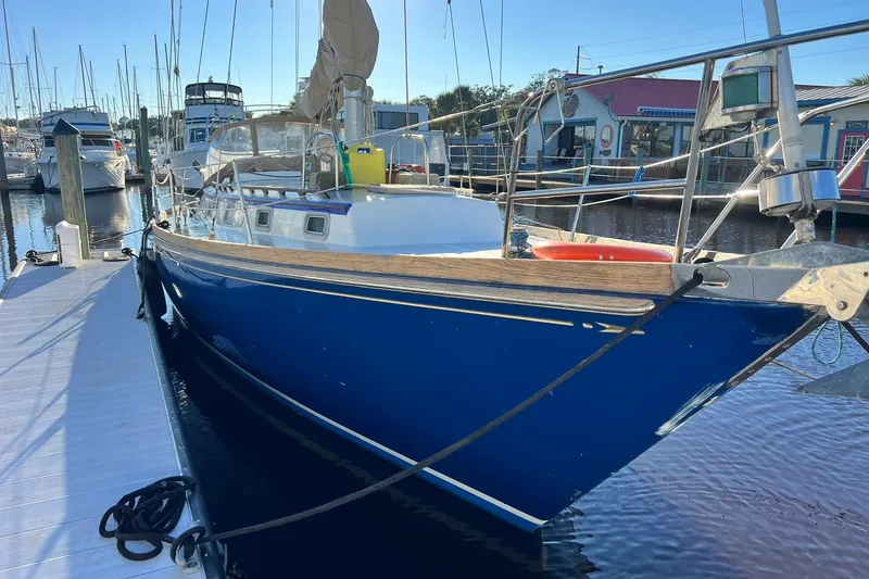 Slide: The Image of 1987 Bristol 41.1 Aft Cockpit sailboat docked at marina, blue hull, sunny day. - 3