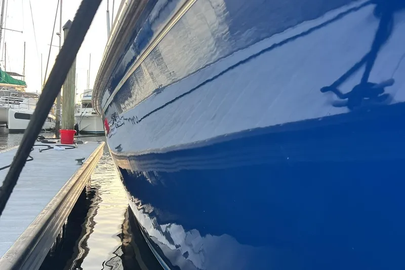 Slide: The Image of 1987 Bristol 41.1 Aft Cockpit sailboat docked, reflecting on calm water. - 5