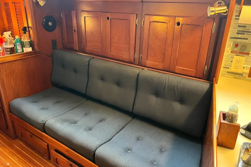 Slide: The Image of 1987 Bristol 41.1 Aft Cockpit interior with wooden cabinets and cushioned seating. - 7