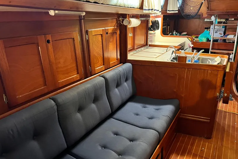 Slide: The Image of Interior of 1987 Bristol 41.1 Aft Cockpit yacht with wooden cabinetry and cushioned seating. - 8