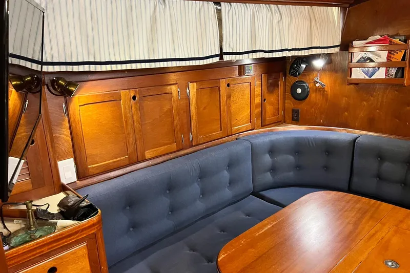 Slide: The Image of 1987 Bristol 41.1 Aft Cockpit interior with wooden cabinetry and blue cushioned seating. - 9