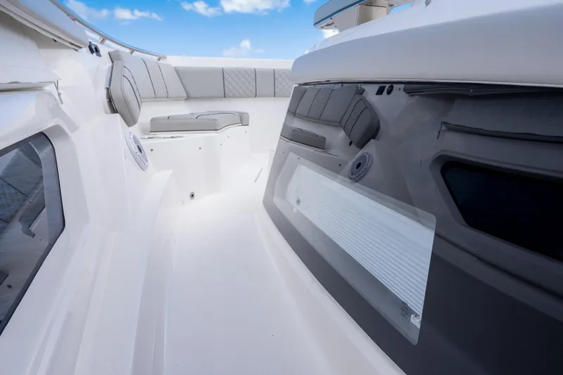 Slide: The Image of 2022 Pursuit S 428 Sport boat interior with cushioned seating and sleek design. - 25