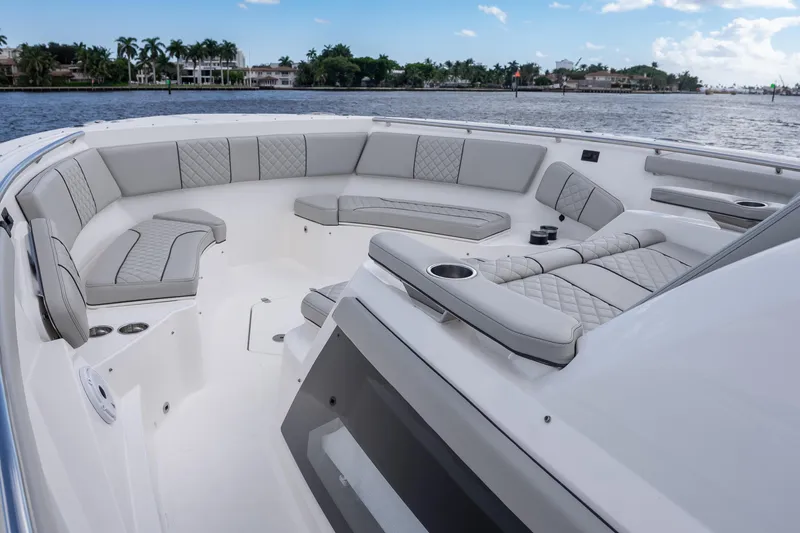 Slide: The Image of Luxurious seating area on 2022 Pursuit S 428 Sport boat, with waterfront view. - 26