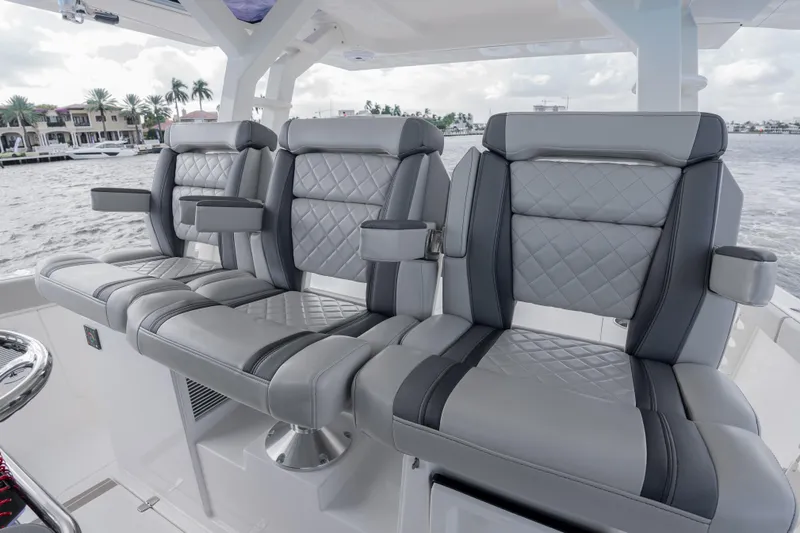Slide: The Image of Luxurious seating on 2022 Pursuit S 428 Sport boat, featuring quilted gray upholstery. - 27