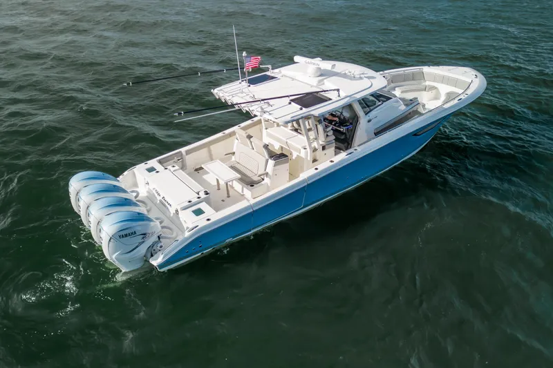 Slide: The Image of 2022 Pursuit S 428 Sport boat with four Yamaha engines on open water. - 3