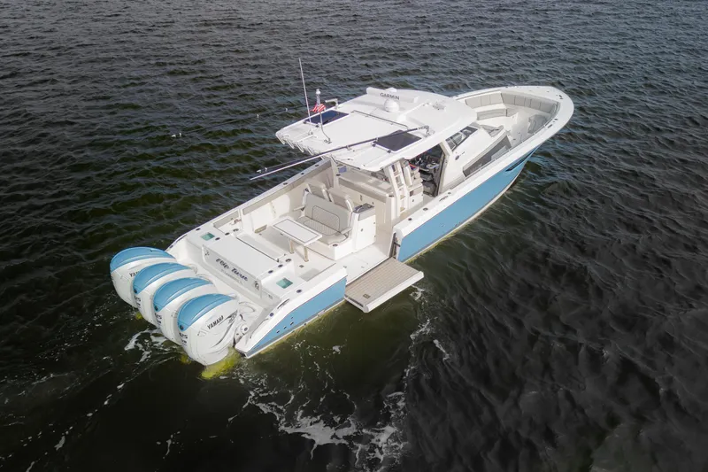 Slide: The Image of 2022 Pursuit S 428 Sport boat with triple Yamaha engines on open water. - 4