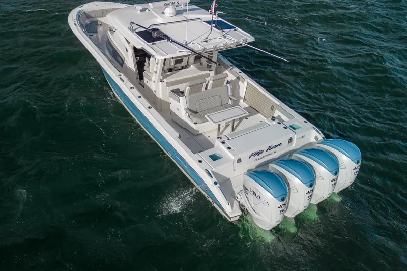 Slide: The Image of 2022 Pursuit S 428 Sport boat with four Yamaha engines on the water. - 7