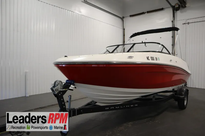 The Image of 2021 Bayliner VR5 Bowrider OB in showroom, red and white design, on trailer. - 1