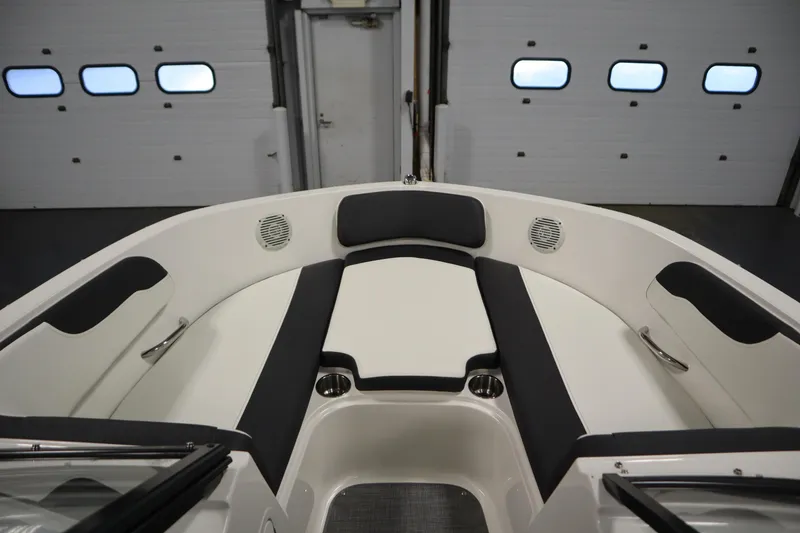 Slide: The Image of 2021 Bayliner VR5 Bowrider OB interior with cushioned seating and cup holders. - 11