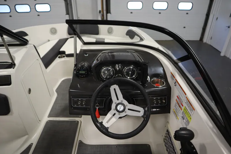 Slide: The Image of 2021 Bayliner VR5 Bowrider OB dashboard with steering wheel and control panel. - 18