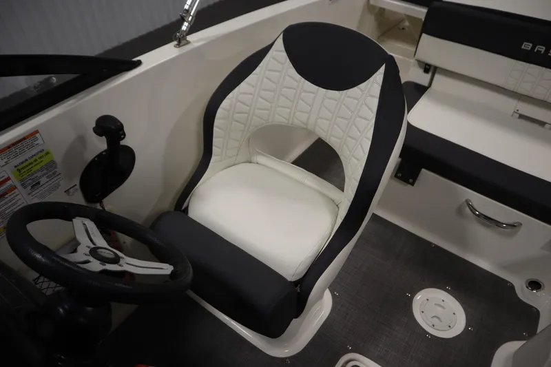 Slide: The Image of 2021 Bayliner VR5 Bowrider OB interior with steering wheel and cushioned seat. - 26