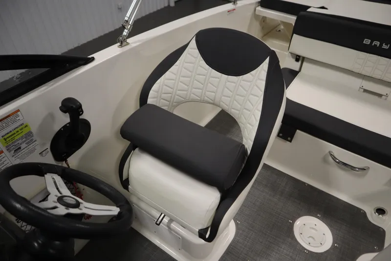 Slide: The Image of 2021 Bayliner VR5 Bowrider OB interior with steering wheel and cushioned seating. - 27