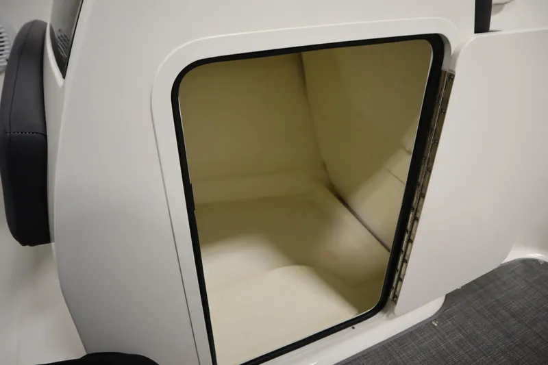 Slide: The Image of 2021 Bayliner VR5 Bowrider OB storage compartment, open and empty, with white interior. - 31