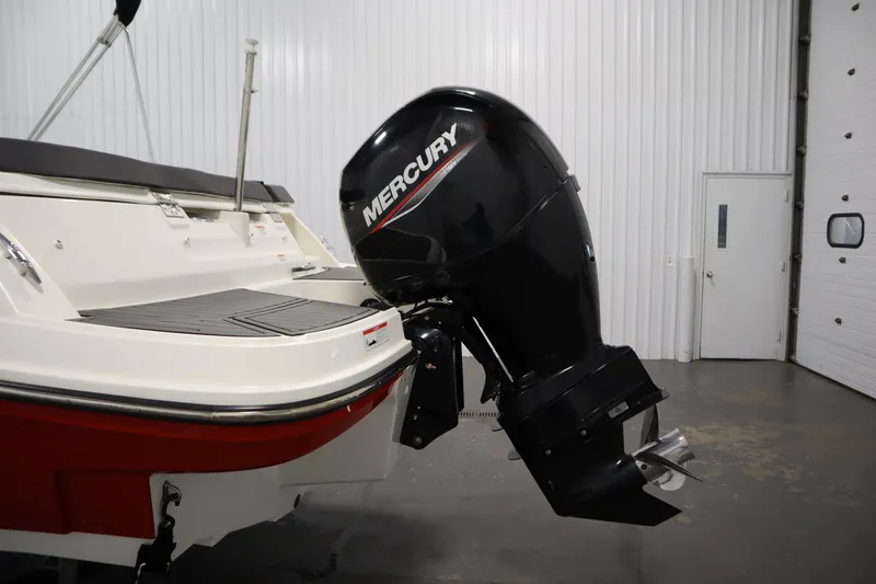Slide: The Image of 2021 Bayliner VR5 Bowrider OB with Mercury outboard motor in a garage setting. - 44