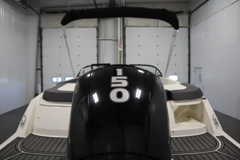 Slide: The Image of 2021 Bayliner VR5 Bowrider OB with 150 HP engine in a garage setting. - 46