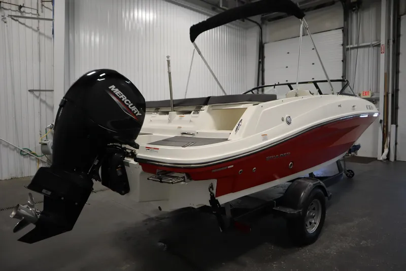 Slide: The Image of 2021 Bayliner VR5 Bowrider OB with Mercury outboard in a garage setting. - 5