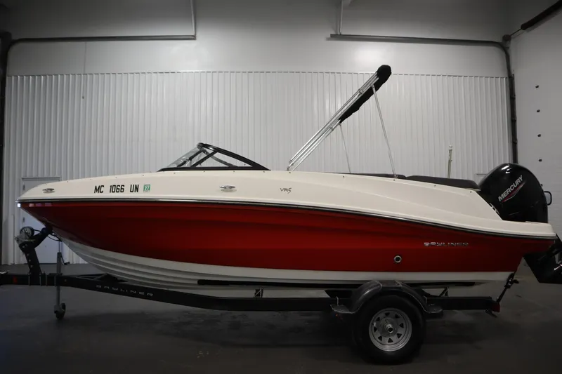 Slide: The Image of 2021 Bayliner VR5 Bowrider OB, red and white, on trailer in indoor setting. - 8