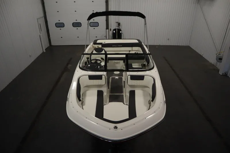 Slide: The Image of 2021 Bayliner VR5 Bowrider OB in a spacious indoor storage facility. - 9