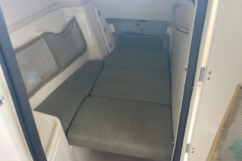 Slide: The Image of 2011 Grady-White Freedom 307 cabin interior with cushioned seating and storage netting. - 15