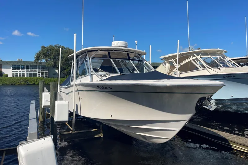 Slide: The Image of 2011 Grady-White Freedom 307 boat docked on a sunny day. - 2