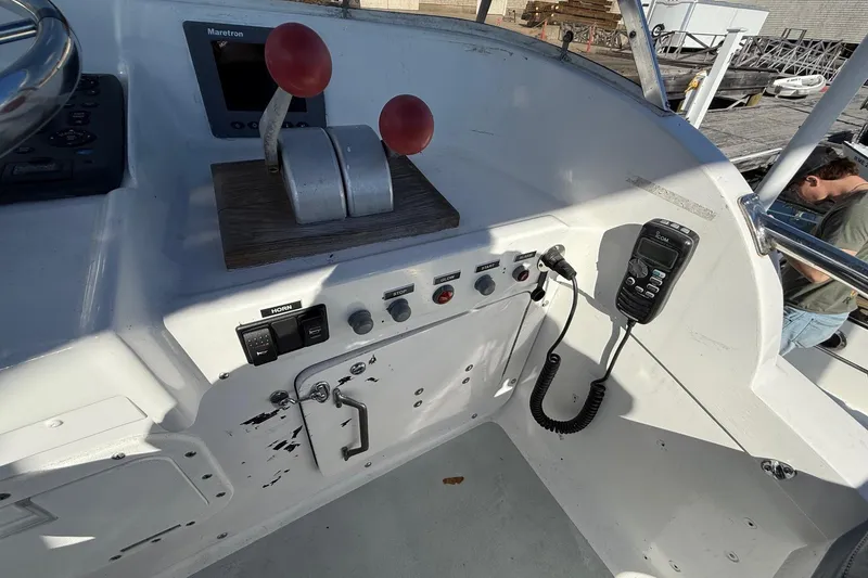 Slide: The Image of Control panel of a 1963 Bertram 31 Flybridge Cruiser with throttle levers and communication device. - 20