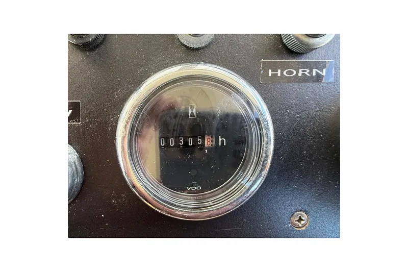 Slide: The Image of Hour meter on 1963 Bertram 31 Flybridge Cruiser dashboard, showing 3058 hours. - 28