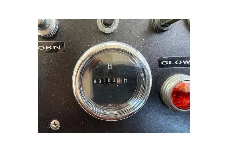 Slide: The Image of Close-up of a 1963 Bertram 31 Flybridge Cruiser dashboard with hour meter reading 303. - 29