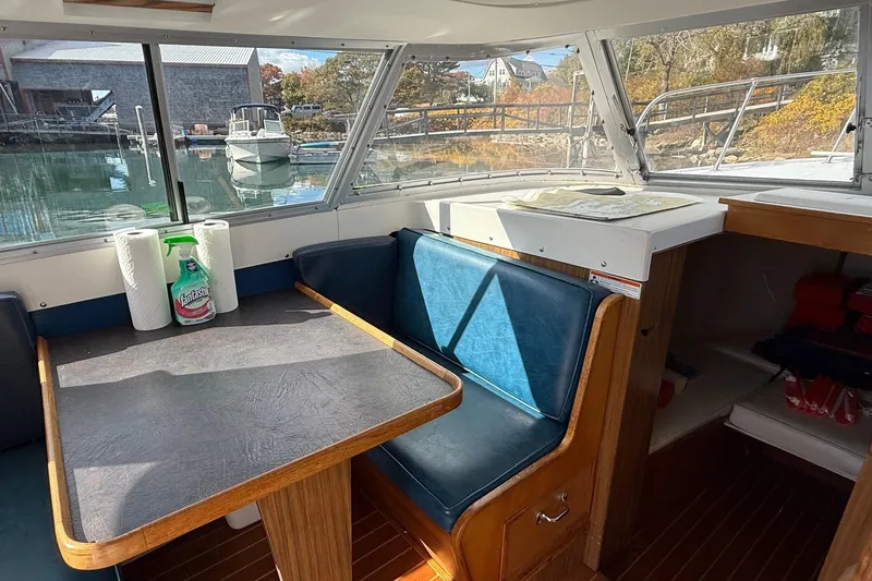 Slide: The Image of Interior of a 1963 Bertram 31 Flybridge Cruiser with table and seating. - 31
