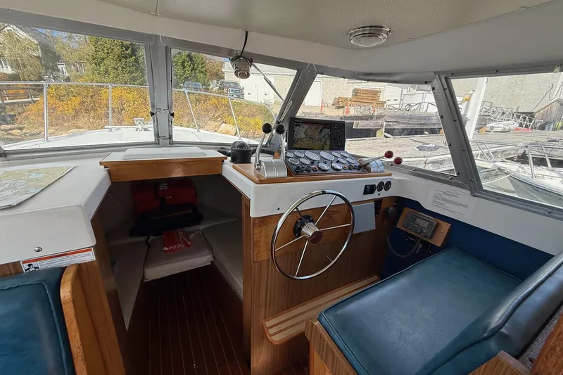 Slide: The Image of 1963 Bertram 31 Flybridge Cruiser helm with vintage controls and navigation equipment. - 32