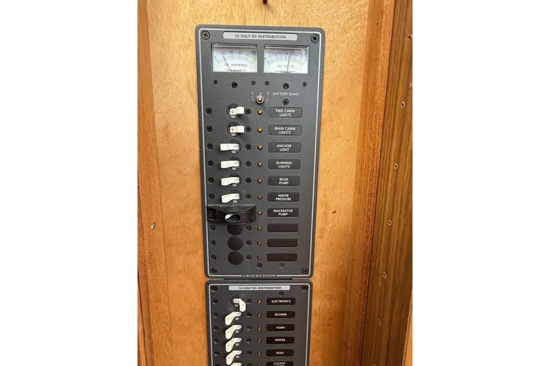 Slide: The Image of Electrical panel on a 1963 Bertram 31 Flybridge Cruiser, featuring switches and gauges. - 41