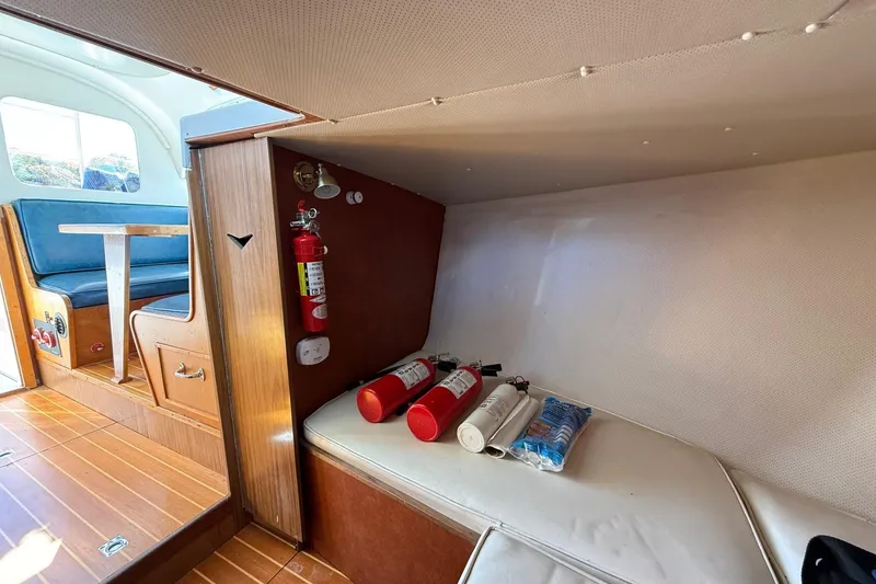 Slide: The Image of Interior of 1963 Bertram 31 Flybridge Cruiser with fire extinguishers and seating area. - 44