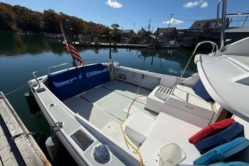 Slide: The Image of 1963 Bertram 31 Flybridge Cruiser docked in a serene marina setting. - 8