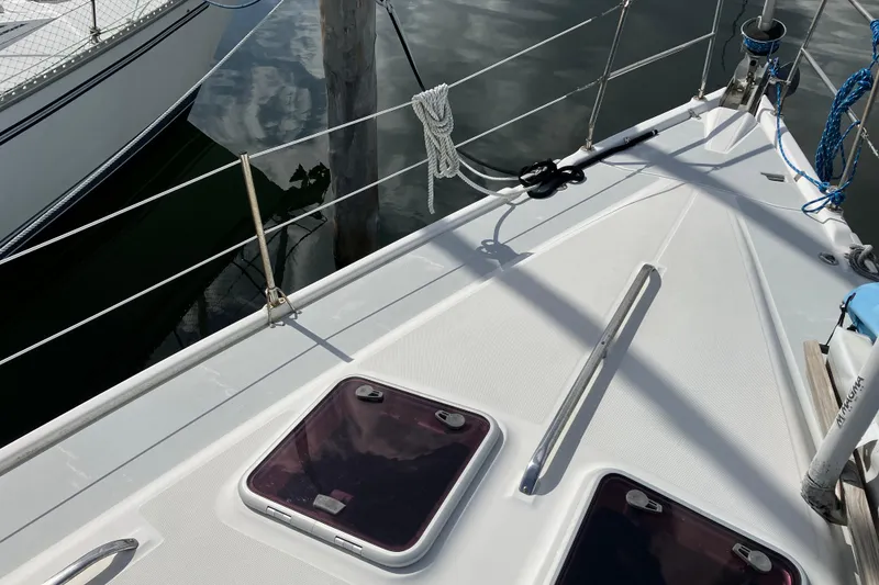 Slide: The Image of Deck view of a 2002 Hunter 460 sailboat, featuring hatches and rigging. - 14