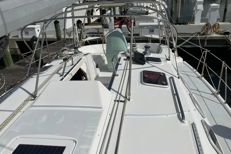 Slide: The Image of 2002 Hunter 460 sailboat deck view at marina, showcasing sleek design and equipment. - 15