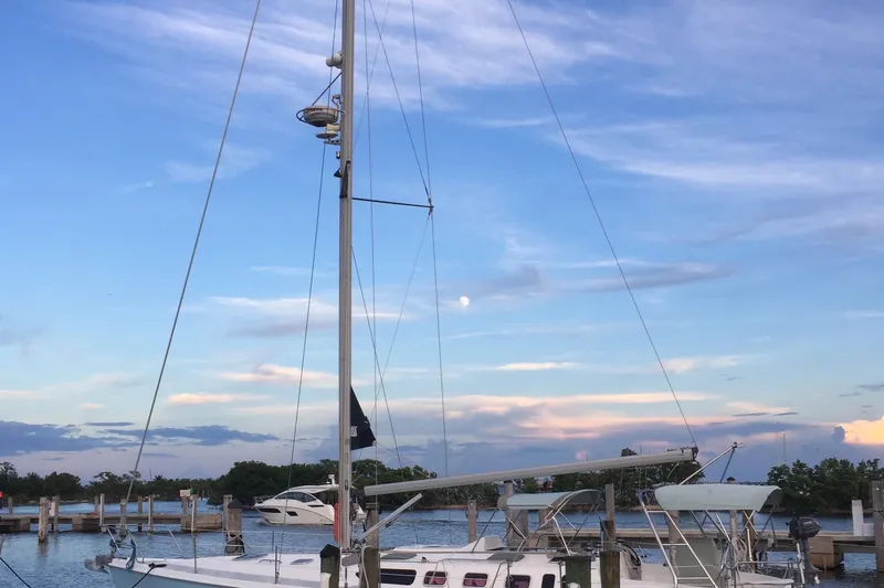 Slide: The Image of Sailboat Hunter 460, 2002 model, docked at marina under a vibrant evening sky. - 2