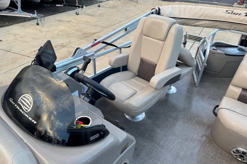 Slide: The Image of 2023 Sun Tracker Fishin' Barge 20 DLX interior with steering console and comfortable seating. - 4