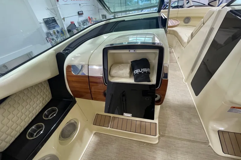 Slide: The Image of 2026 Chris-Craft Launch 31 GT interior with open storage compartment and luxury seating. - 25