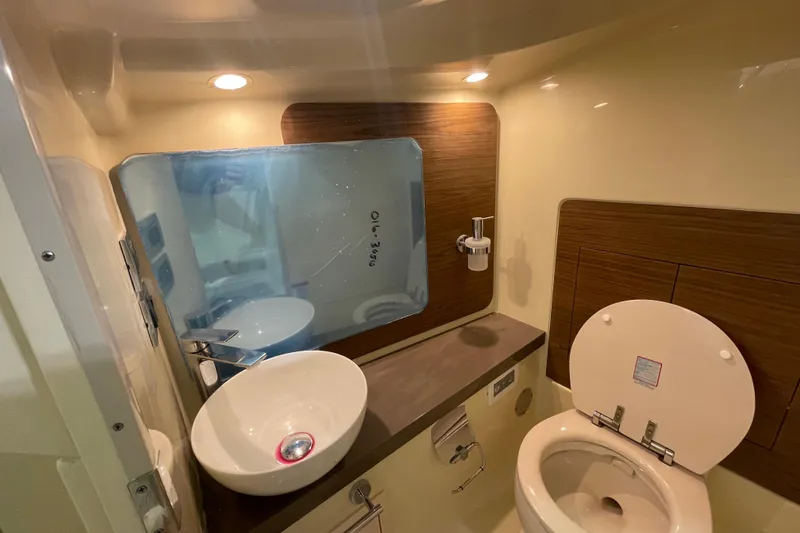 Slide: The Image of 2026 Chris-Craft Launch 31 GT bathroom with modern sink, mirror, and toilet. - 27