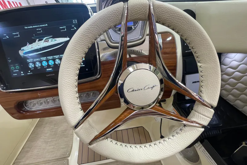 Slide: The Image of 2026 Chris-Craft Launch 31 GT steering wheel and dashboard with digital display. - 34